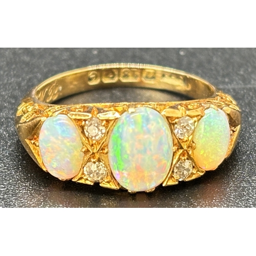 10 - An Edwardian 18ct yellow gold opal and diamond ring. 3 oval cut opals and 4 small round cut diamonds... 