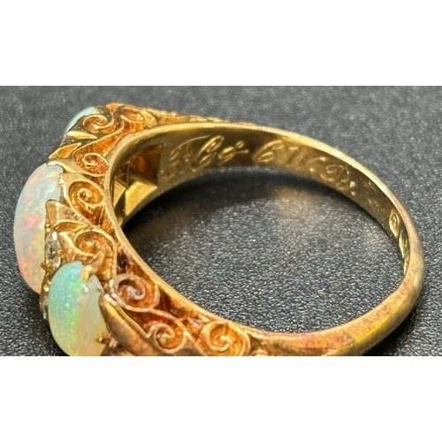 10 - An Edwardian 18ct yellow gold opal and diamond ring. 3 oval cut opals and 4 small round cut diamonds... 