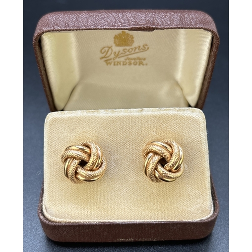 12 - A Large pair of vintage 9ct gold knot design stud earrings in plain and diamond patterned gold. Hall... 