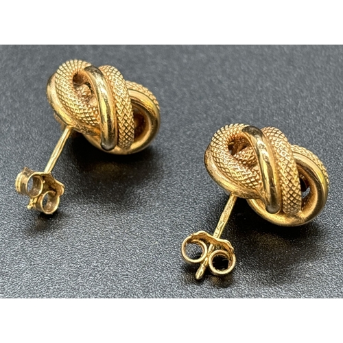 12 - A Large pair of vintage 9ct gold knot design stud earrings in plain and diamond patterned gold. Hall... 