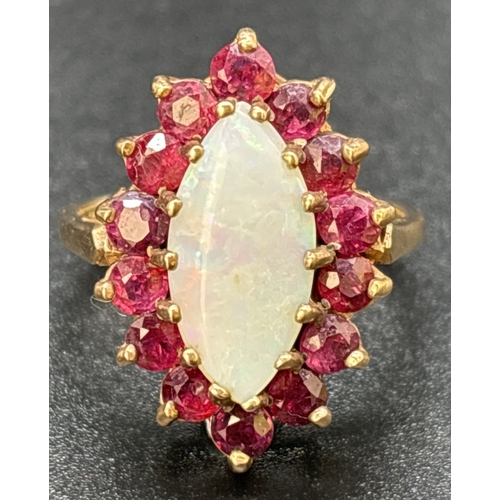 16 - A vintage 9ct yellow gold, opal and ruby dress ring. Large central marquise cut opal surrounded by 1... 