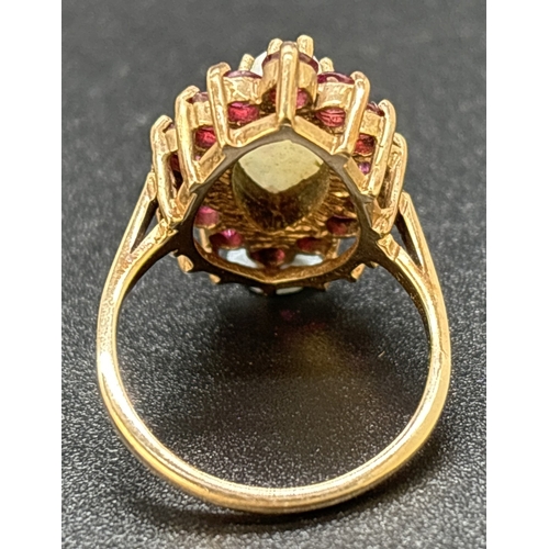 16 - A vintage 9ct yellow gold, opal and ruby dress ring. Large central marquise cut opal surrounded by 1... 