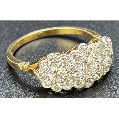 22 - An 18ct gold & diamond triple cluster ring set with 27 brilliant cut diamonds. Mounted in platinum m... 