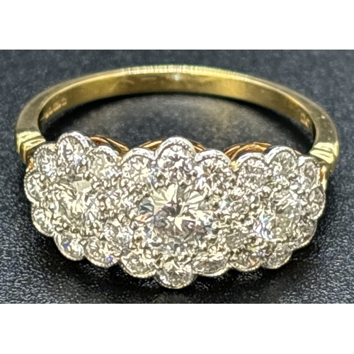 22 - An 18ct gold & diamond triple cluster ring set with 27 brilliant cut diamonds. Mounted in platinum m... 