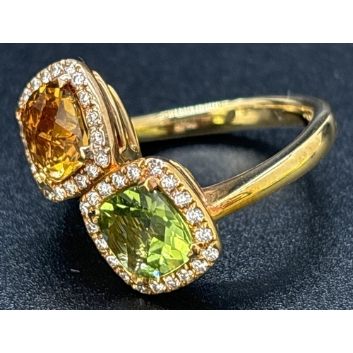 24 - An 18ct gold citrine, peridot and diamond double cluster ring in an offset crossover style.  A 1.4ct... 