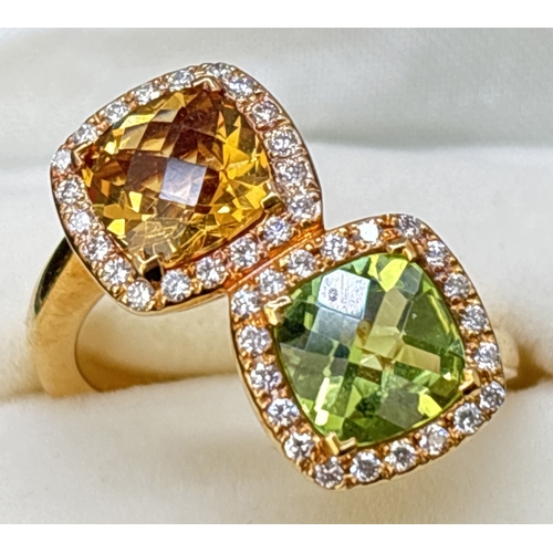 24 - An 18ct gold citrine, peridot and diamond double cluster ring in an offset crossover style.  A 1.4ct... 