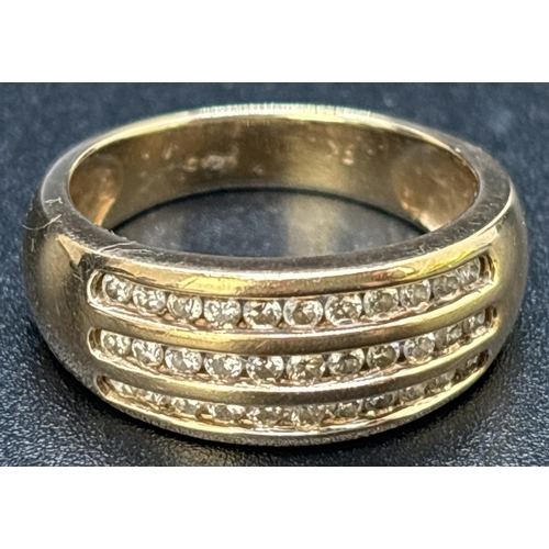 25 - A 9ct gold band ring set with 3 rows of channel set round cut diamonds totaling 0.5ct. Gold and diam... 