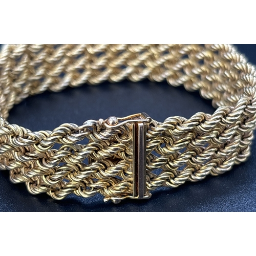 27 - A boxed vintage 4 row rope chain bracelet with push clip clasp and double safety clip. Gold marks to... 