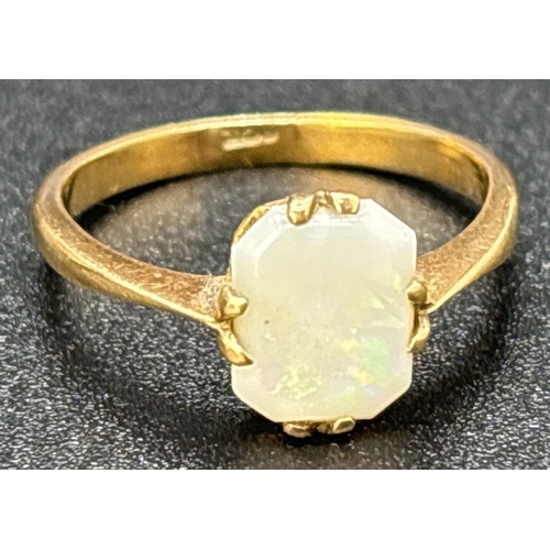 32 - A vintage 9ct gold square cut opal dress ring with pronged claw setting. Gold mark inside band. Opal... 