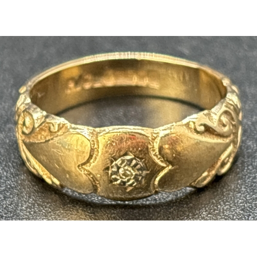 35 - A vintage 9ct gold band style ring set with a single small round cut diamond. Heart and scroll engra... 