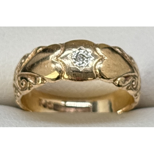 35 - A vintage 9ct gold band style ring set with a single small round cut diamond. Heart and scroll engra... 