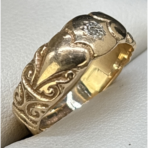 35 - A vintage 9ct gold band style ring set with a single small round cut diamond. Heart and scroll engra... 