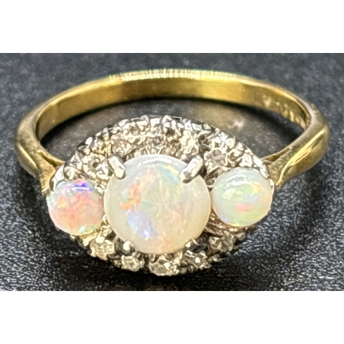 38 - A vintage 18ct yellow gold and platinum opal and diamond ring. Round cut central opal flanked by 2 s... 