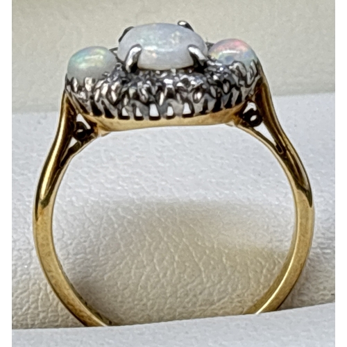 38 - A vintage 18ct yellow gold and platinum opal and diamond ring. Round cut central opal flanked by 2 s... 