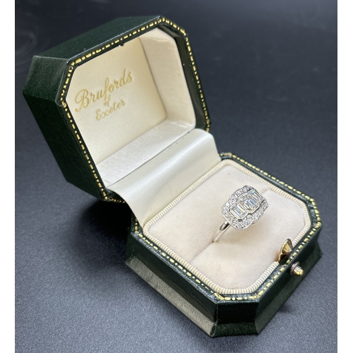 42 - An Art Deco design 18ct white gold and diamond ring. Comprising 3 rub over set emerald cut diamonds ... 