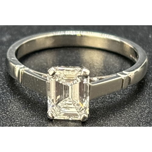 43 - A single stone 1.05ct emerald cut diamond ring mounted in a platinum four claw setting with parallel... 