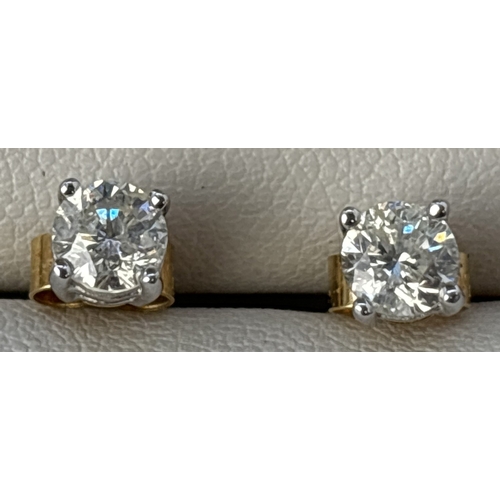 44 - A pair of diamond stud earrings mounted in 18ct white gold with 18ct yellow gold posts and butterfly... 