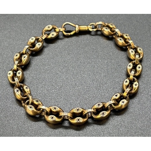 46 - A Victorian yellow gold oval link bracelet with pierced work star decoration and Albert clasp. No go... 