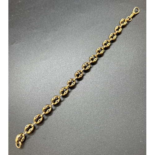 46 - A Victorian yellow gold oval link bracelet with pierced work star decoration and Albert clasp. No go... 