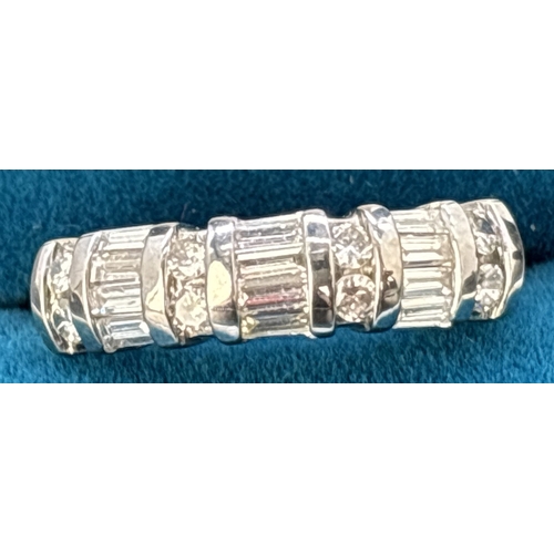 48 - A baguette and round cut diamond half eternity ring set in 18ct white gold. Alternating rows of 4 ba... 