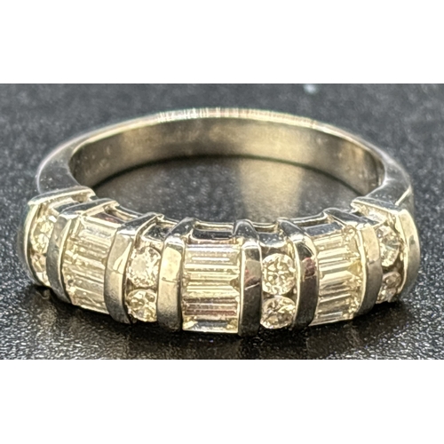 48 - A baguette and round cut diamond half eternity ring set in 18ct white gold. Alternating rows of 4 ba... 