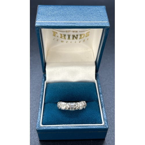 48 - A baguette and round cut diamond half eternity ring set in 18ct white gold. Alternating rows of 4 ba... 