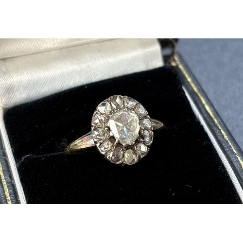 49 - A Victorian 18ct gold rose cut diamond cluster ring in a cut down setting. A central stone surrounde... 