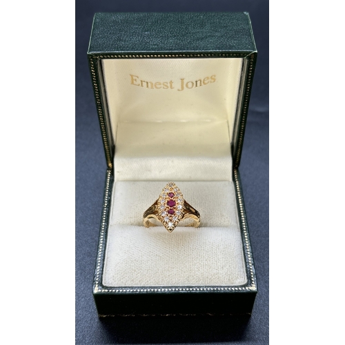 52 - A diamond and ruby set 18ct yellow gold ring with marquise shaped mount, fluted style shoulders and ... 