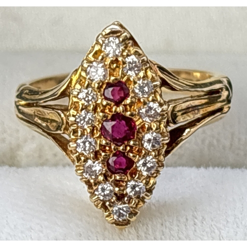 52 - A diamond and ruby set 18ct yellow gold ring with marquise shaped mount, fluted style shoulders and ... 