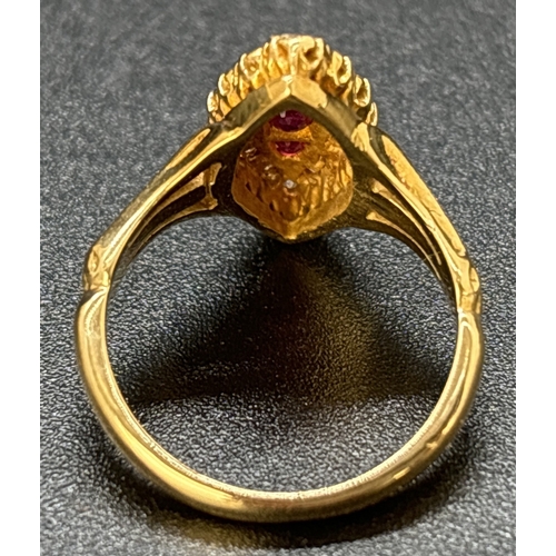 52 - A diamond and ruby set 18ct yellow gold ring with marquise shaped mount, fluted style shoulders and ... 