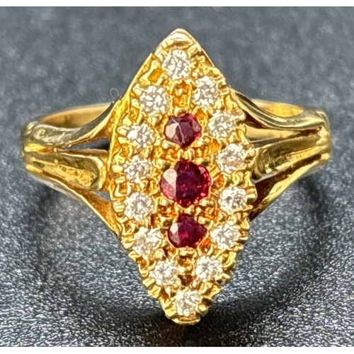 52 - A diamond and ruby set 18ct yellow gold ring with marquise shaped mount, fluted style shoulders and ... 