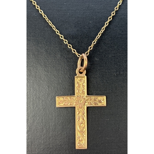 56 - A vintage 9ct gold cross pendant with engraved foliate decoration to front, on an 18