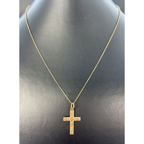 56 - A vintage 9ct gold cross pendant with engraved foliate decoration to front, on an 18