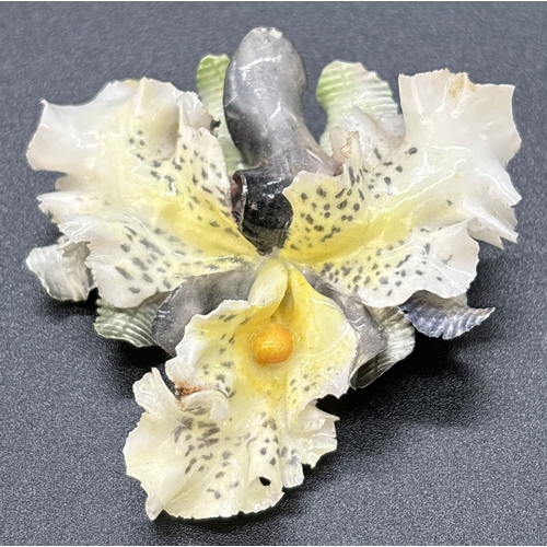 58 - A hand painted Royal Crown derby ceramic Orchid brooch in yellow and grey. Approx. 5.25 x 5cm, maker... 