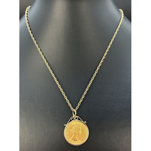 66 - A 1958 Elizabeth II sovereign coin in a 9ct gold pendant mount, on a 9ct gold 20