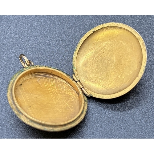 67 - A vintage 9ct gold front and back circular shaped locket with floral engraved decoration and empty c... 