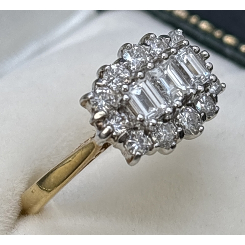 69 - An 18ct yellow gold diamond cluster ring comprising 3 emerald cut claw set central diamonds surround... 