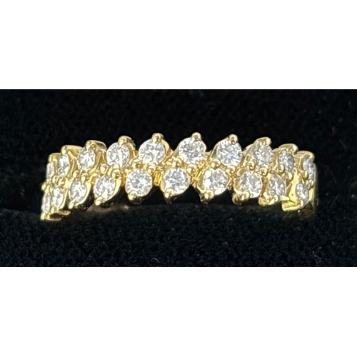 72 - An 18ct yellow gold half eternity ring with 2 offset rows of small brilliant cut diamonds with a tot... 