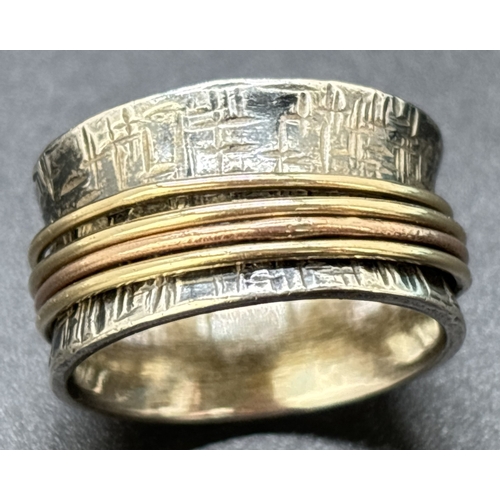 75 - A contemporary design 958 silver spinner ring. Bamboo effect design to a 11mm wide band with 4 plain... 