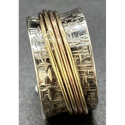 75 - A contemporary design 958 silver spinner ring. Bamboo effect design to a 11mm wide band with 4 plain... 