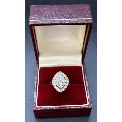 81 - A 9ct yellow gold marquise shaped diamond ring comprising a central raised panel set with 9 x 0.04ct... 