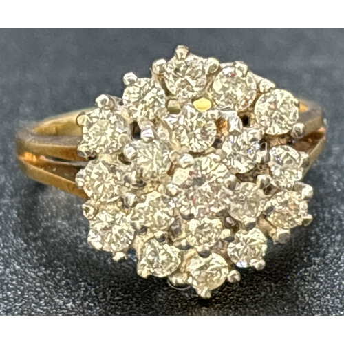 85 - A 9ct gold graduating tiered, diamond cluster ring with split shoulders and plain shank. 19 brillian... 