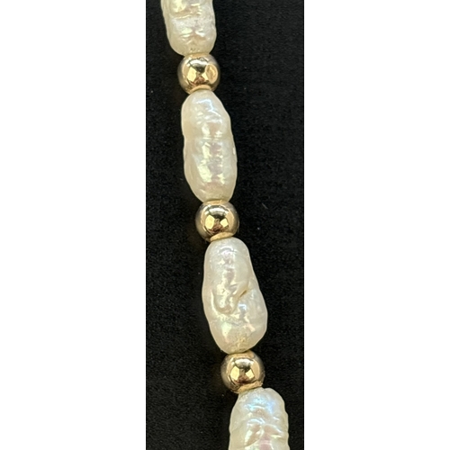 87 - A vintage 28 inch alternating freshwater keshi pearl and 9ct gold round bead necklace. With 9ct gold... 