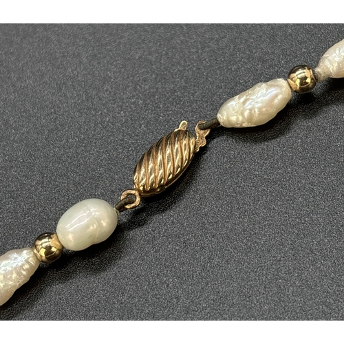 87 - A vintage 28 inch alternating freshwater keshi pearl and 9ct gold round bead necklace. With 9ct gold... 