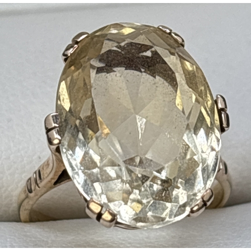 92 - A 9ct gold large oval cut pale yellow citrine cocktail ring. Double prong set in a raised mount with... 