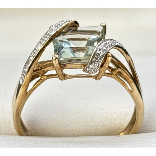 97 - A 9ct gold wrap over design green amethyst and diamond dress ring. Central square cut green amethyst... 