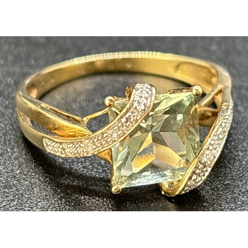 97 - A 9ct gold wrap over design green amethyst and diamond dress ring. Central square cut green amethyst... 