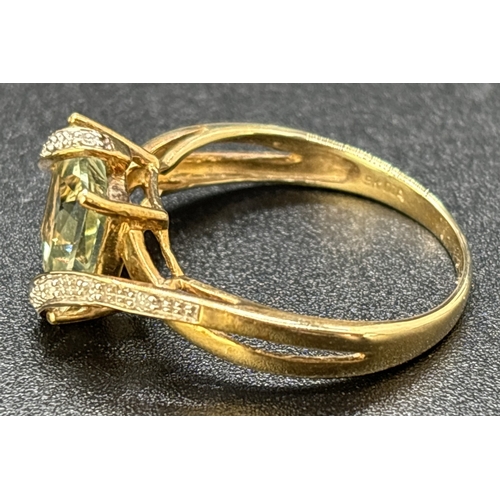 97 - A 9ct gold wrap over design green amethyst and diamond dress ring. Central square cut green amethyst... 