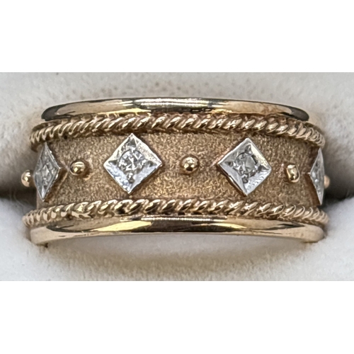 103 - A brushed and plain 9ct yellow and white gold band ring set with 5 small diamonds. 8mm wide band wit... 