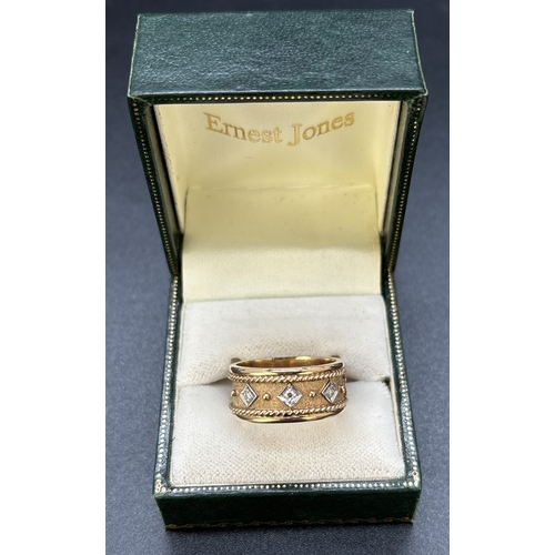 103 - A brushed and plain 9ct yellow and white gold band ring set with 5 small diamonds. 8mm wide band wit... 